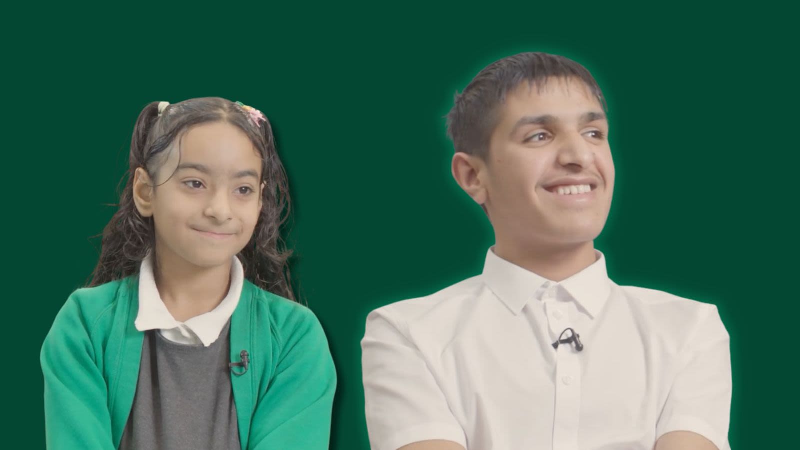 A picture of two smiling refugee children - Aisha, year 5, and Mirwahid, year 8